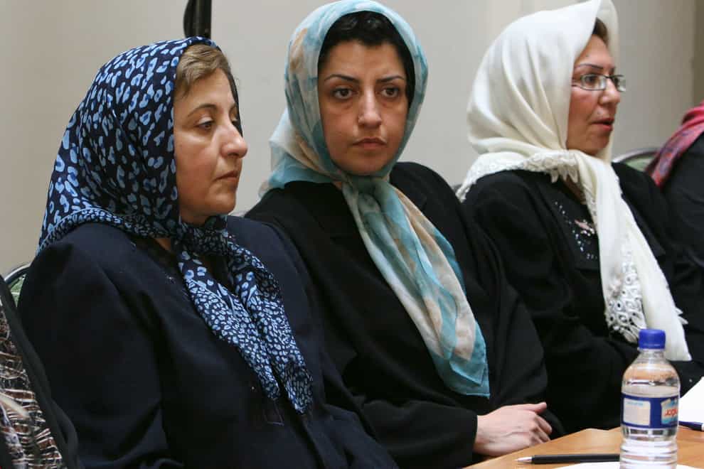 Narges Mohammadi, centre, sits next to Nobel Peace Prize winner Shirin Ebadi, left, while attending a meeting on women’s rights in Tehran (AP Photo/Vahid Salemi, File)