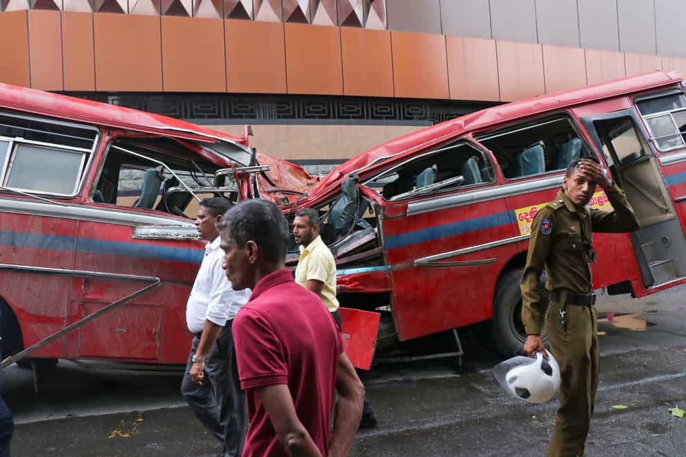 Five people were killed when a large tree toppled on to a moving bus in Colombo during heavy rain (AP Photo)