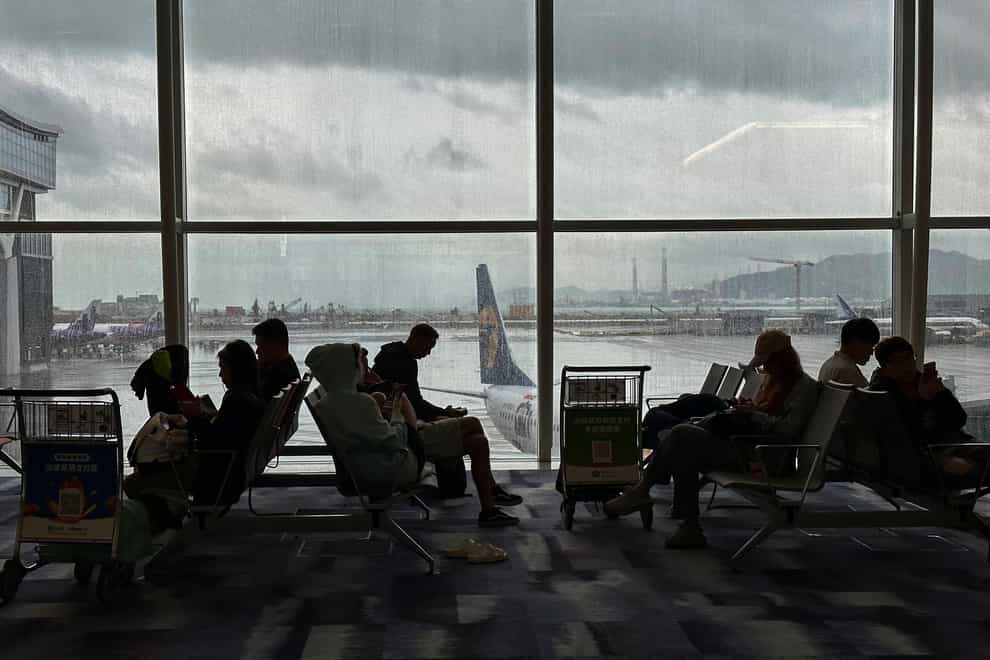 Travellers wait at the departures hall at Hong Kong International Airport (Emily Wang/AP/PA)