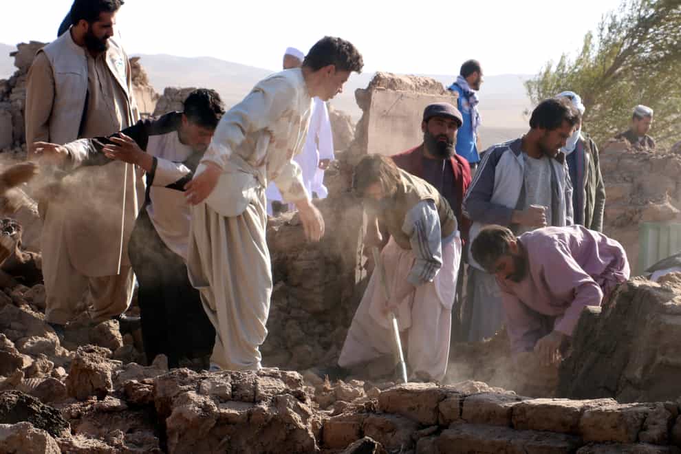 Afghan men search for victims after an earthquake in Zenda Jan district in Herat province (Omid Haqjoo/AP/PA)