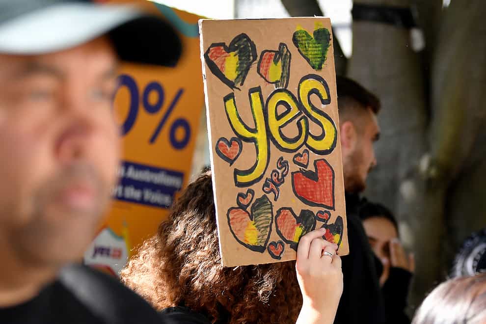 A woman holds a hand-made Yes sign as supporters gather at the Redfern Community Centre in Sydney on Monday (Bianca De Marchi/AAP/AP)