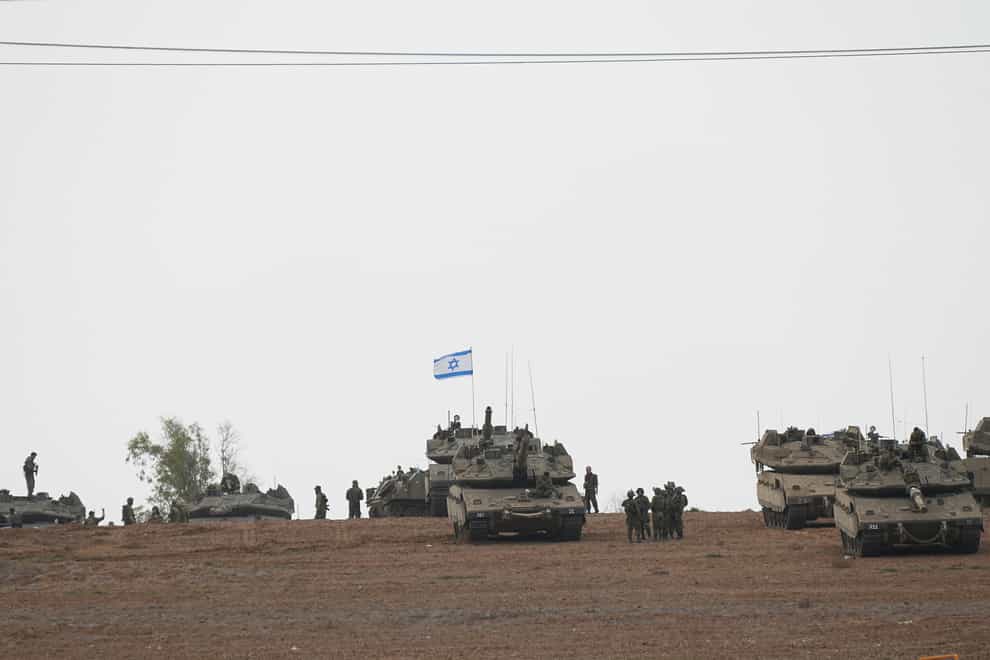 Israeli soldiers are seen in a staging ground near the Israeli Gaza border in southern Israel (Ohad Zwigenberg/AP/PA)