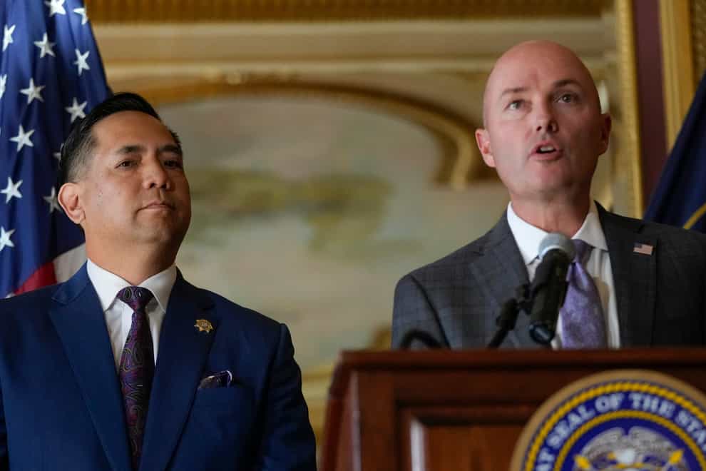 Utah Attorney General Sean Reyes listens as Gov Spencer Cox speaks during a press conference following the announcement that Utah filed a lawsuit against TikTok (Bethany Baker/The Salt Lake Tribune via AP/PA)