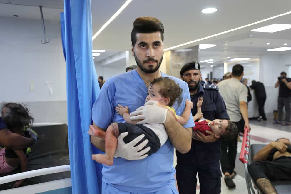 Wounded children are taken to Shifa Hospital in Gaza City (Ali Mahmoud/AP)