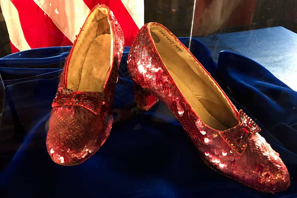 A pair of ruby slippers once worn by actress Judy Garland in The Wizard of Oz sit on display at an FBI office in Minnesota in 2018 (Jeff Baenen/AP/PA)