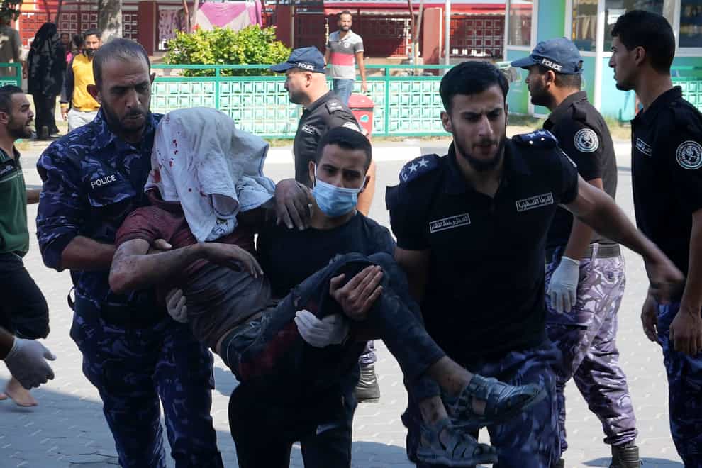 Palestinians wounded in Israeli air strikes on Gaza Strip are brought to al-Aqsa hospital (Adel Hana/AP)