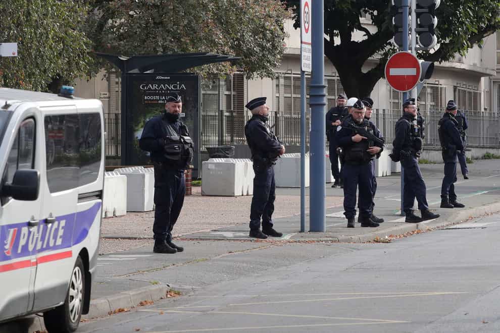 Police officers stand in front the Gambetta high school (AP)