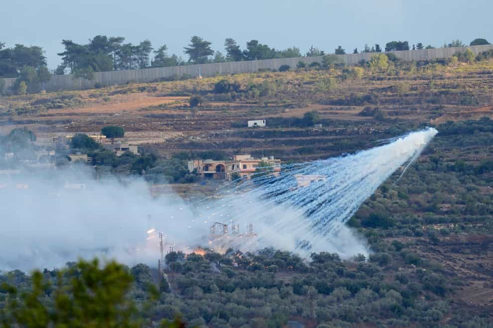 A shell from Israeli artillery explodes over a house in al-Bustan, a Lebanese border village with Israel, south Lebanon (Hussein Malla/AP)