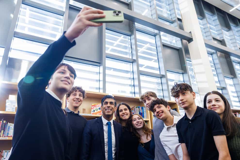 Prime Minister Rishi Sunak poses for a photograph with sixth form students during a visit to a Jewish school in north London (Jonathan Buckmaster/Daily Express/PA)