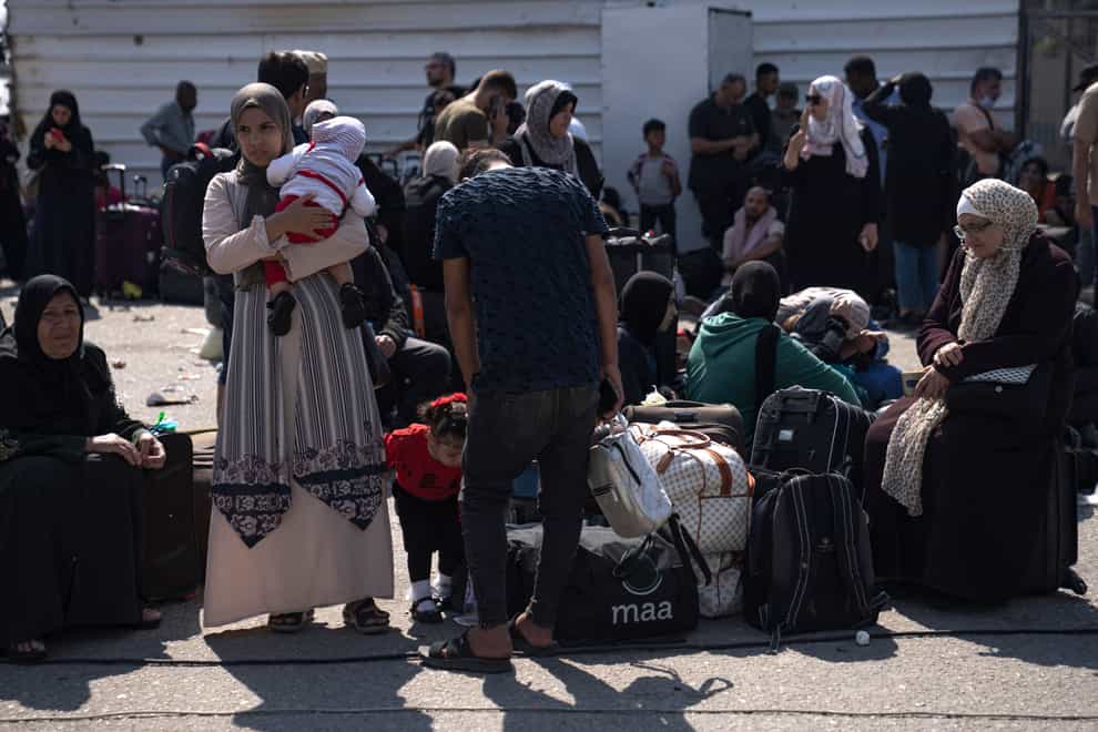 Palestinians wait to cross into Egypt at the Rafah border crossing (AP Photo/Fatima Shbair)