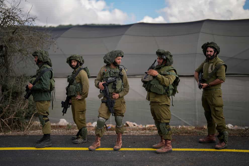 Israeli soldiers patrol along a road near the border between Israel and Lebanon (Francisco Seco/AP)