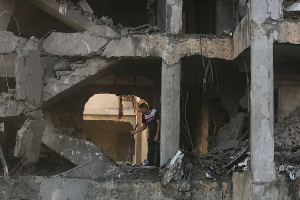 A Palestinian man inspects the remains of a house hit by an Israeli air strike in Khan Younis,(Mohammed Dahman/AP)