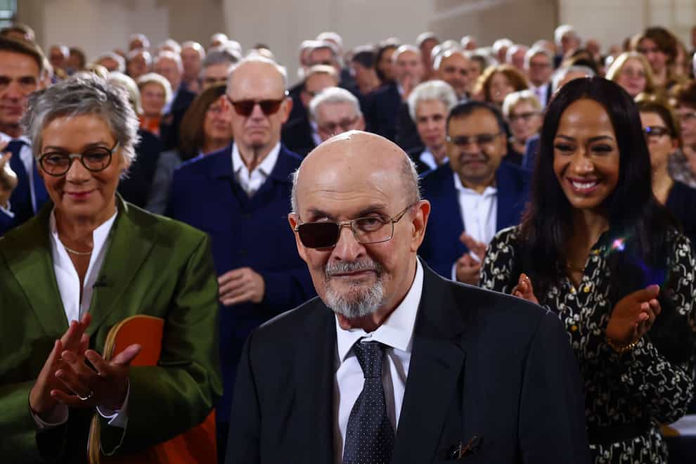 Author Salman Rushdie acknowledges applause as he receives the Peace Prize of the German book trade (Pool via AP)