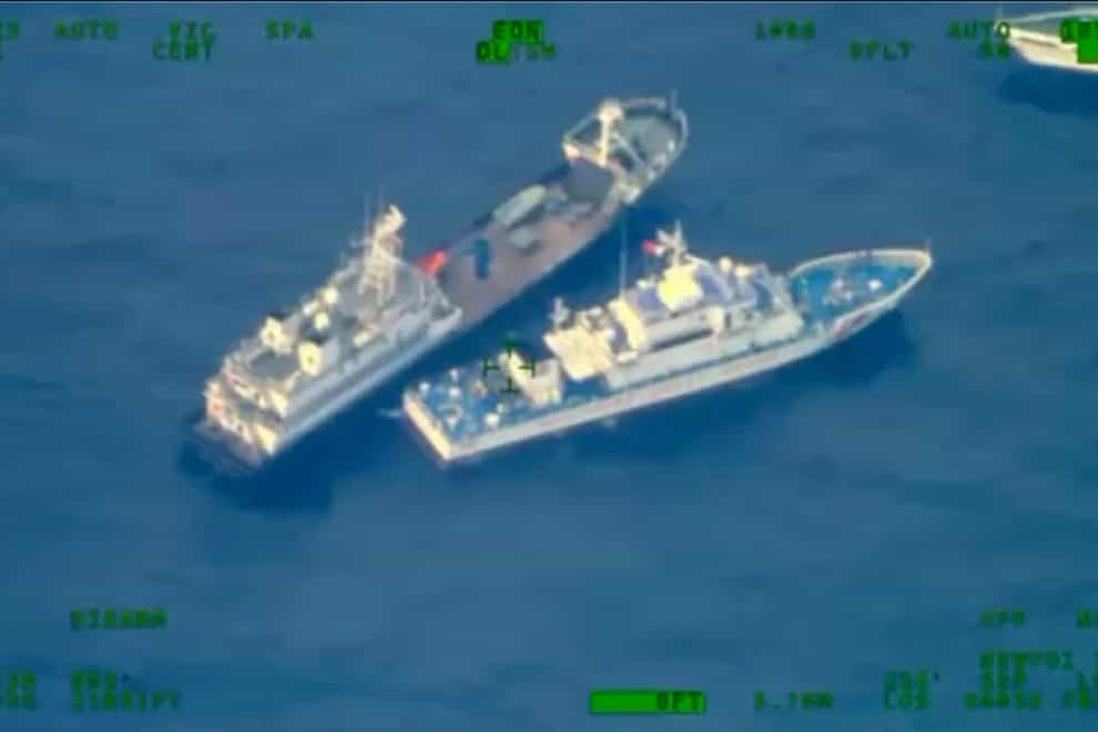 A Chinese vessel is seen near Philippine coastguard vessel BRP Cabra as they approach Second Thomas Shoal (Armed Forces of the Philippines via AP)