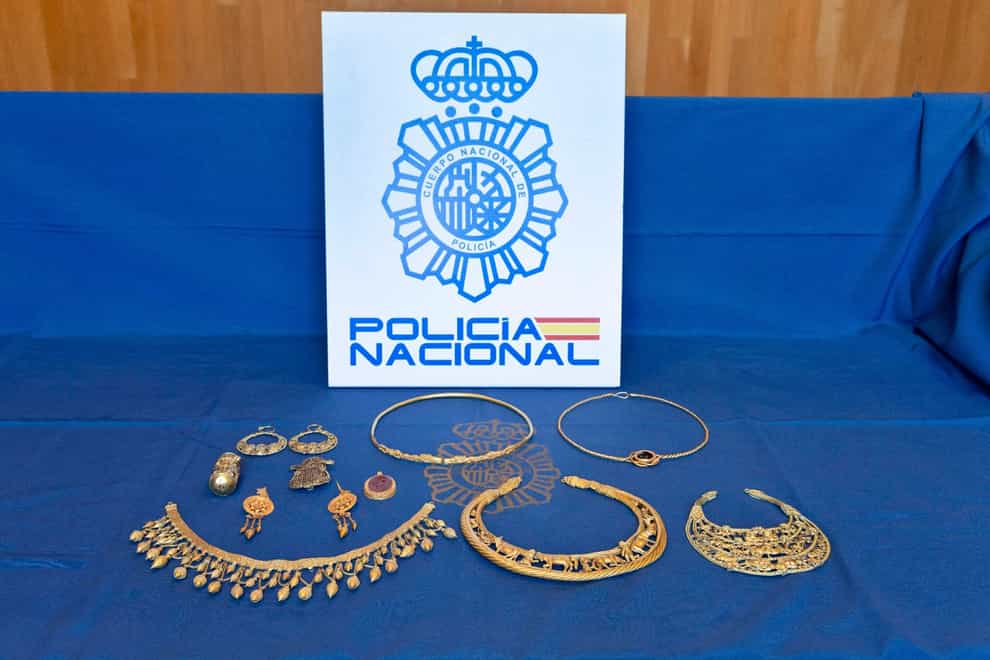 Pieces of ancient gold jewellery are displayed after being recovered by Spanish police (Policia Nacional via AP)