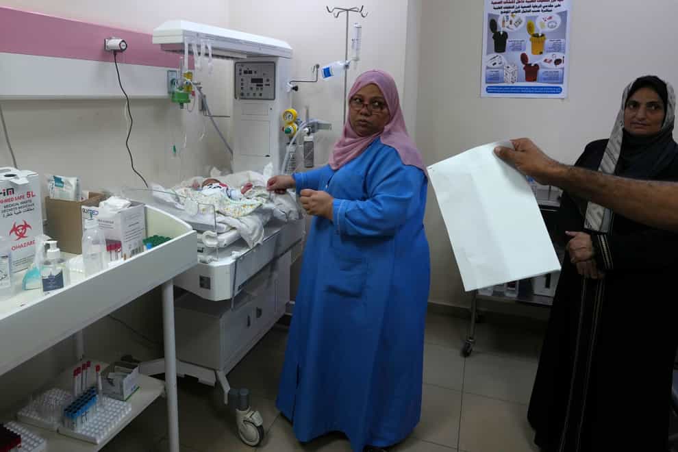 Palestinian doctors treat a prematurely born baby at Al Aqsa Hospital (Adel Hana/AP)