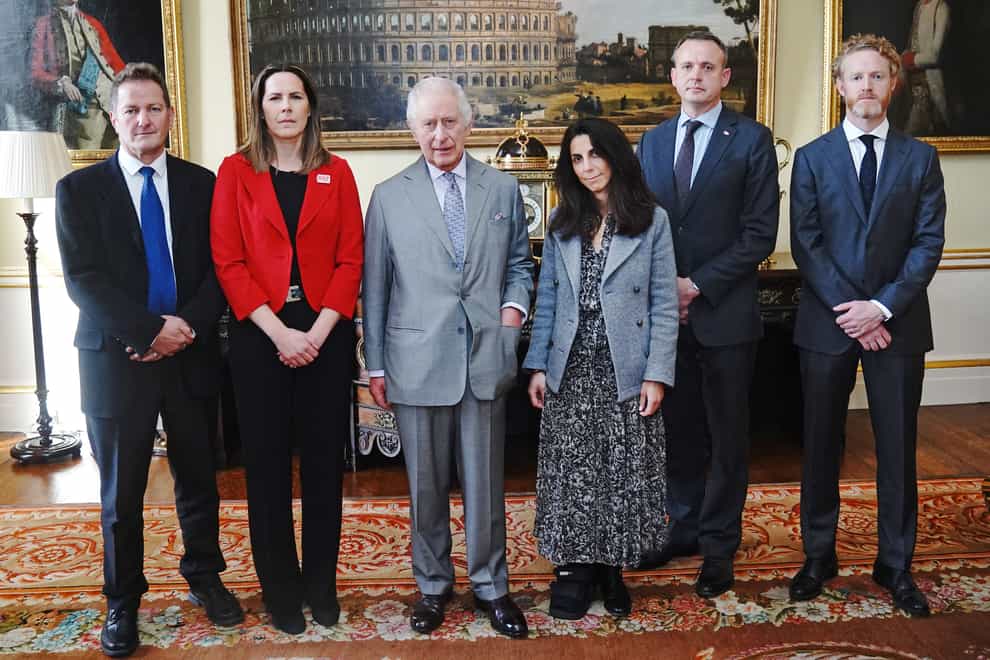 The King with representatives from the aid agencies (Victoria Jones/PA)