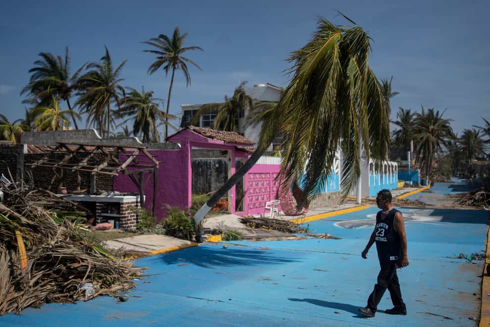 A man walks past damage from Hurricane Otis in Acapulco, Mexico, on Sunday (Felix Marquez/AP)