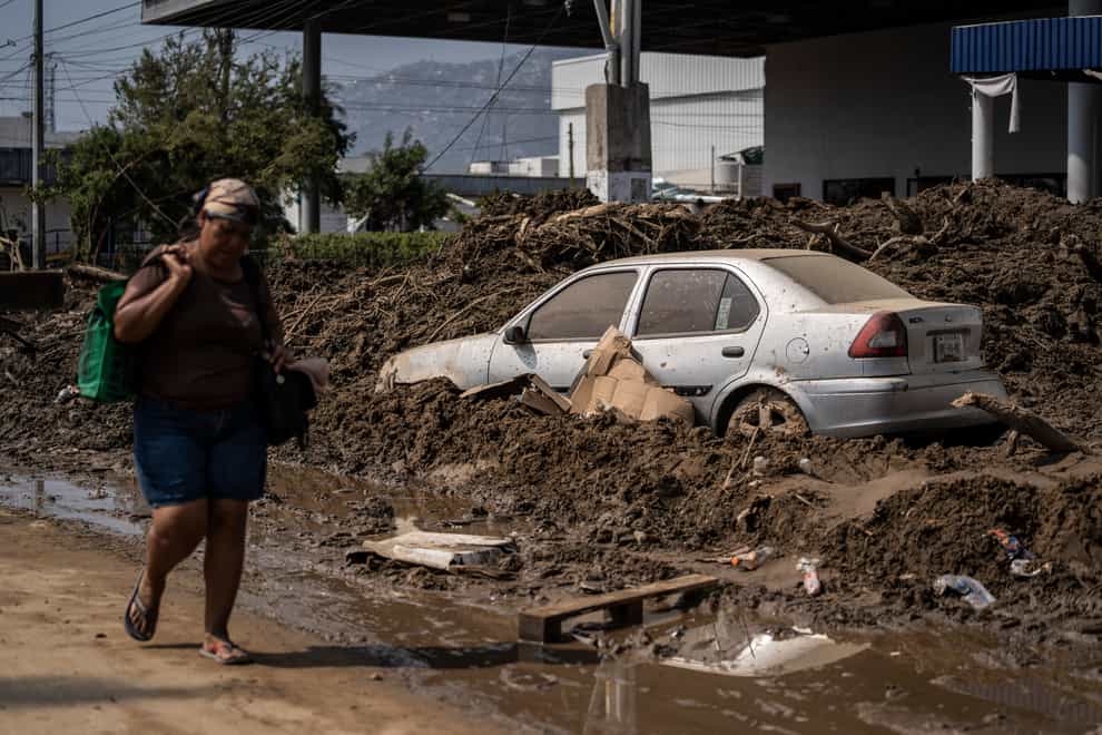 A woman walks through a damaged zone in the aftermath of Hurricane Otis in Acapulco, Mexico (Felix Marquez/AP)