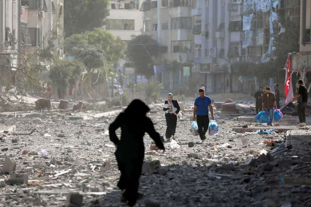 Palestinians leave their homes following Israeli bombardment in Gaza City (AP Photo/Abed Khaled)
