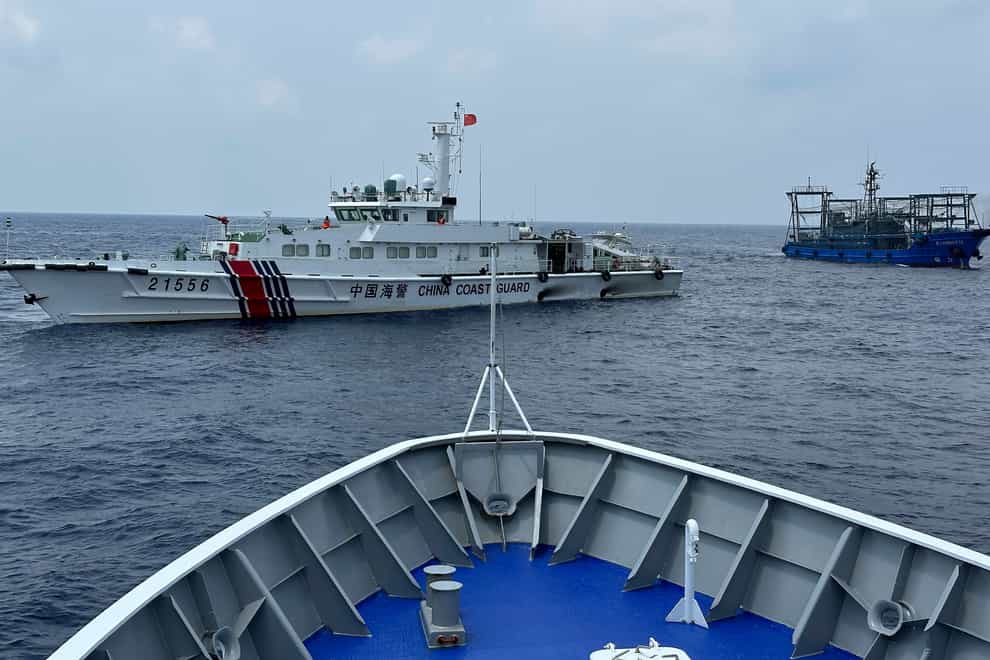 Vessels from the Chinese and Filipino coastguards faced off near another disputed shoal in October (AP Photo/Joeal Calupitan, File)