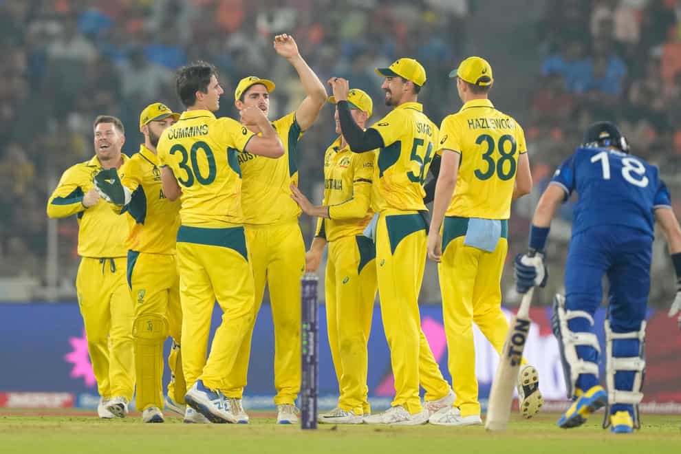 Australia celebrate the dismissal of England’s Liam Livingstone during their 33-run win which ended England’s hopes of staying in the Cricket World Cup (Mahesh Kumar/AP).