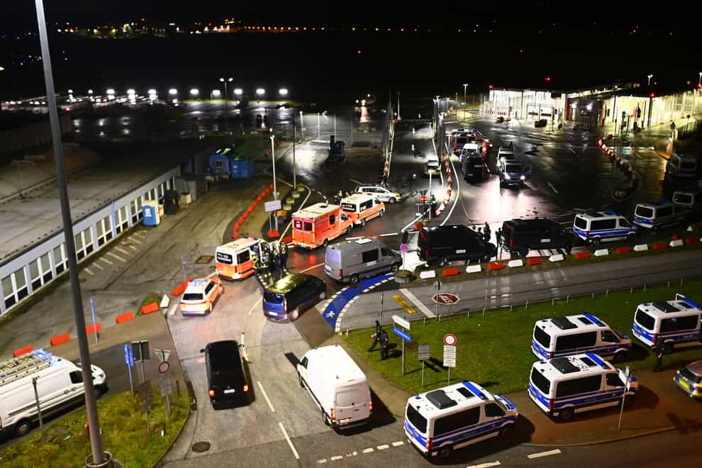 Police vehicles and ambulances at Hamburg airport (Jonas Walzberg/dpa/AP)