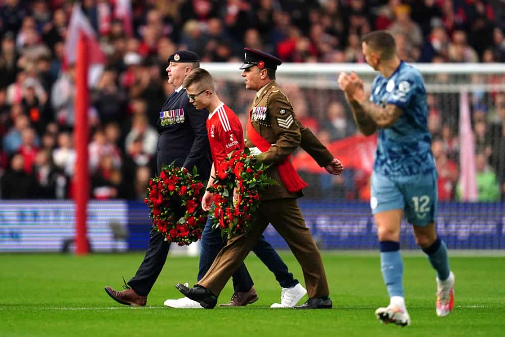 Caiden Storry, centre, performed the Last Post ahead of Forest’s win against Aston Villa (Nick Potts/PA)