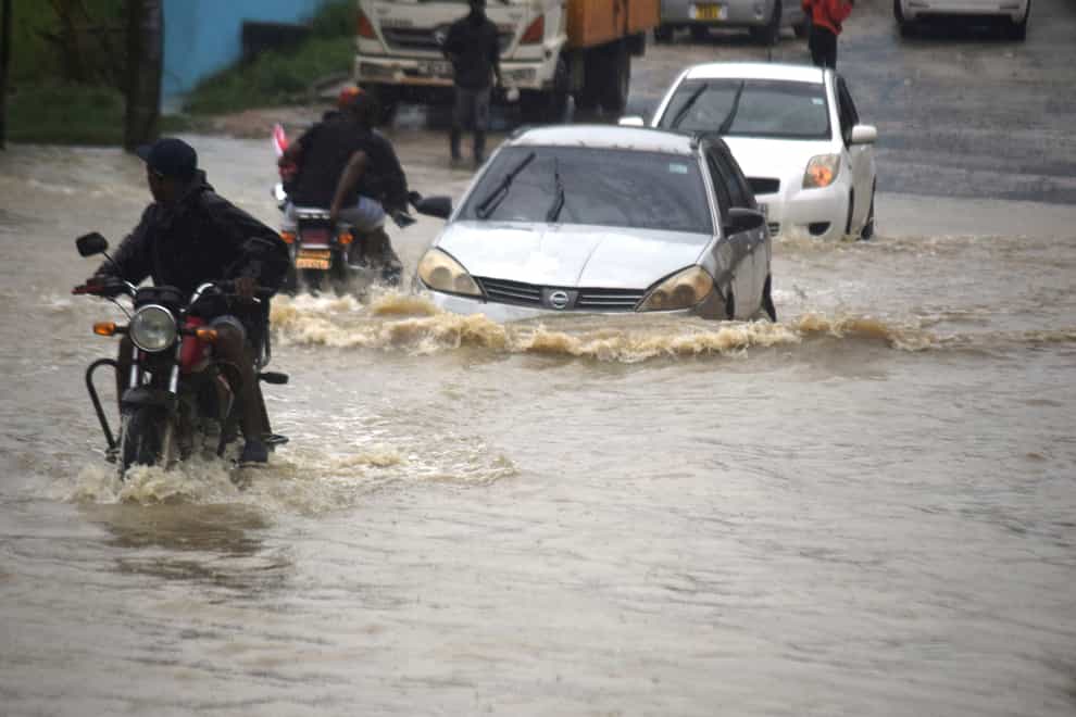 Aid agencies say heavy rains and flash flooding have killed at least 40 people and displaced tens of thousands in Kenya and Somalia (Gideon Maundu/AP)