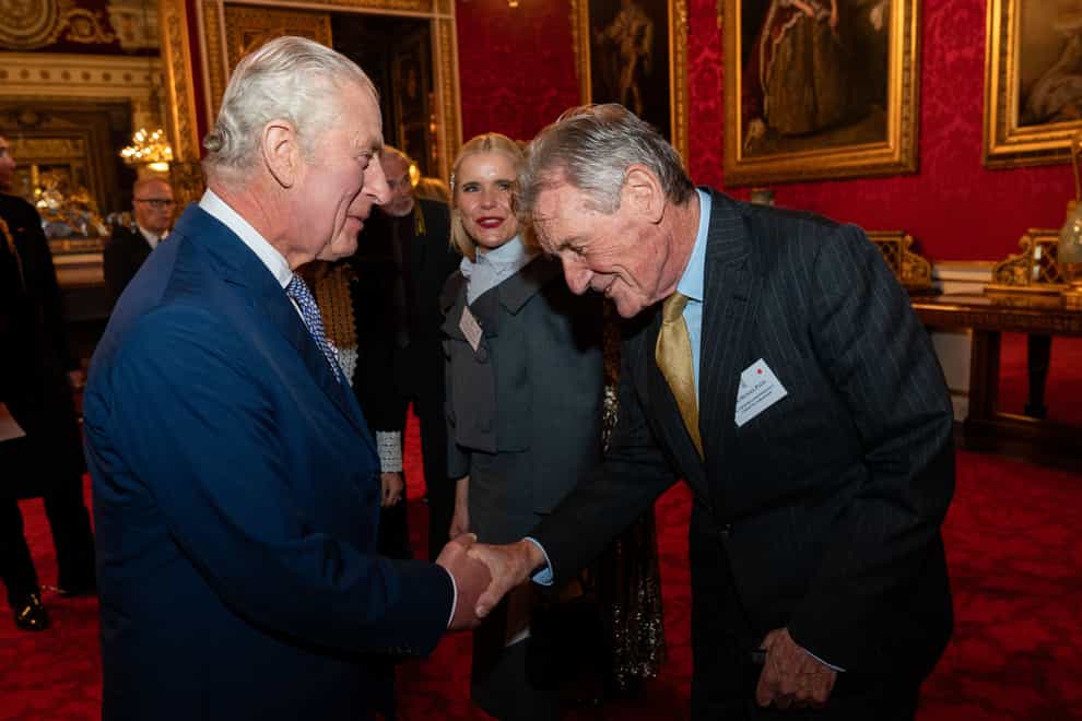 The King with Michael Palin during a reception at Buckingham Palace (PA)
