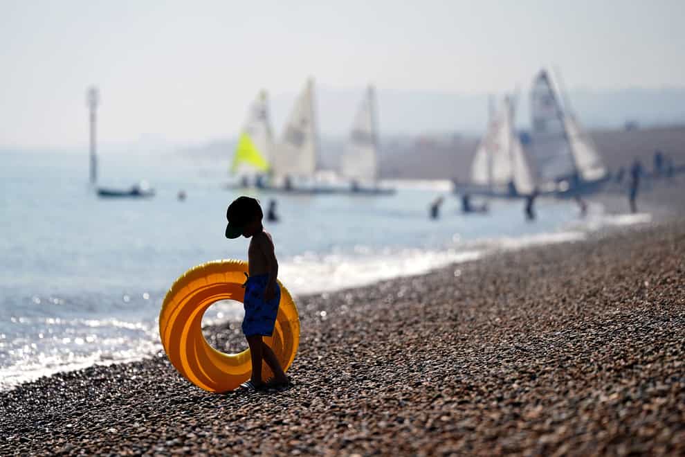 A young person enjoys the hot weather on Deal beach in Kent in early September (PA)