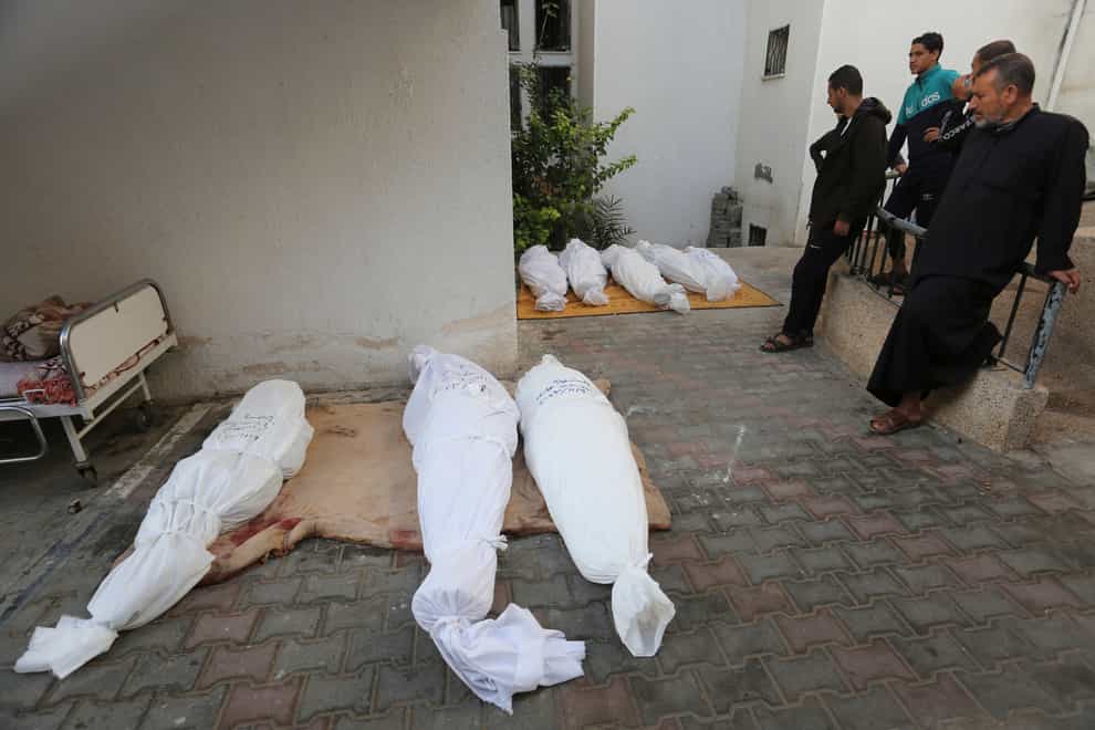 Palestinians stand by the bodies of the Hijazi family who were killed in the Israeli bombardment of the Gaza Strip in Rafah (AP Photo/Hatem Ali)