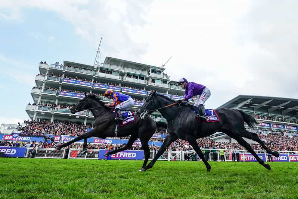 Auguste Rodin ridden by Ryan Moore (left) wins the Epsom Derby (David Davies/PA)