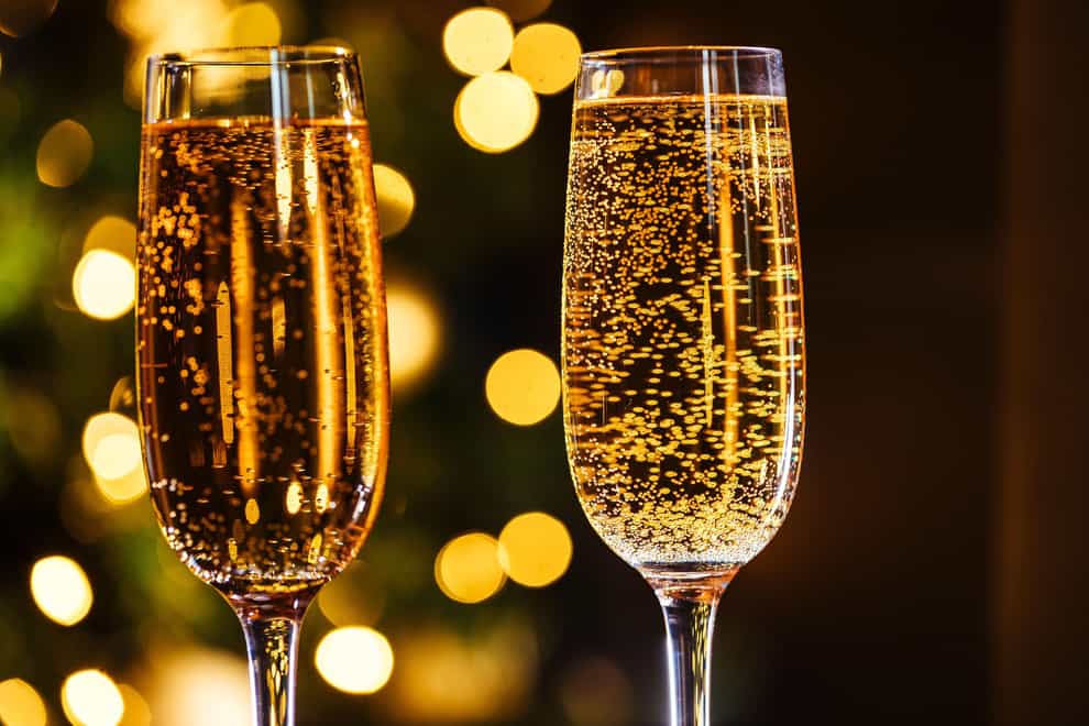 Pop a bottle of fizz to start the festive celebrations (Alamy/PA)
