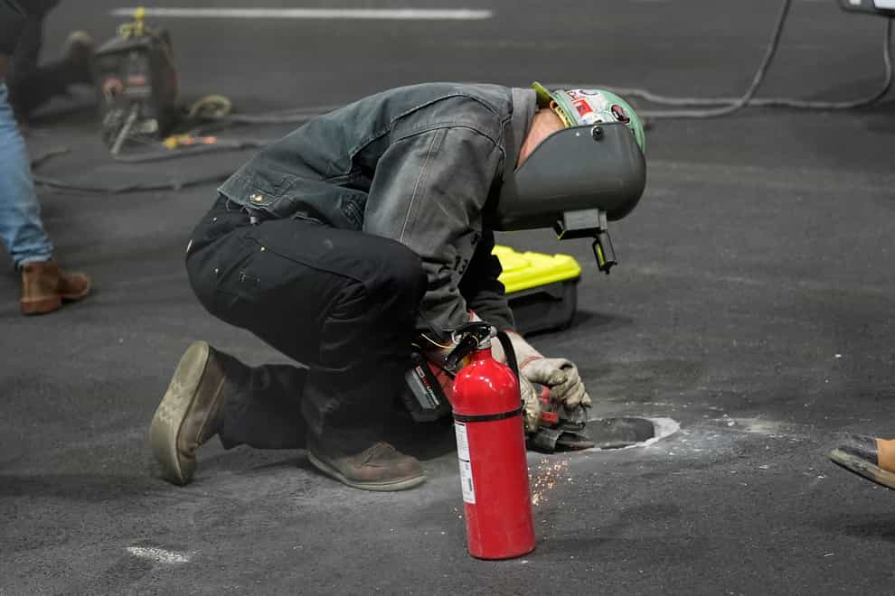 Work is performed on a manhole cover in Las Vegas (Nick Didlick/AP)