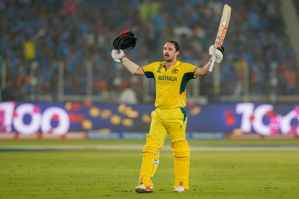 Travis Head raises his bat as he celebrates his century in the World Cup final (Mahesh Kumar A/AP)