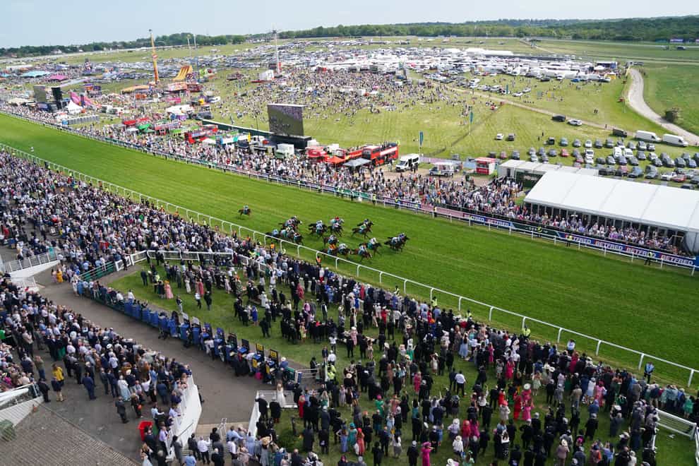Runners and riders in action during The Aston Martin “Dash” Handicap during Derby Day of the 2023 Derby Festival at Epsom Downs Racecourse, Epsom. Picture date: Saturday June 3, 2023.