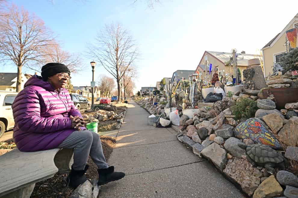 Iris Logan takes a break from dismantling her boulevard rock garden in front of her Sherburne Avenue home in St Paul, Minnesota (John Autey/Pioneer Press via AP)