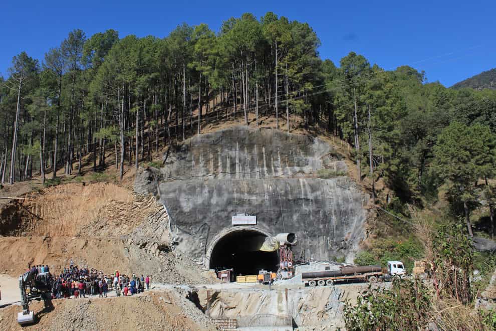 People watch rescue and relief operations at the site of an under-construction road tunnel that collapsed in mountainous Uttarakhand state (AP)