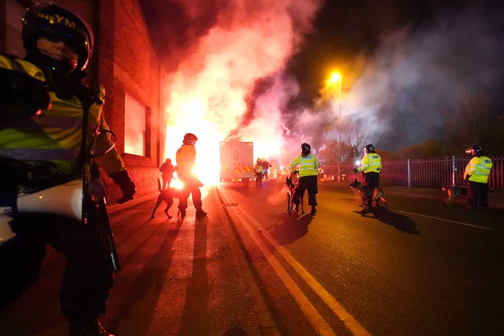 Police officers with dogs as flares are set off outside the stadium before the UEFA Europa Conference League Group E match at Villa Park, Birmingham. Picture date: Thursday November 30, 2023.