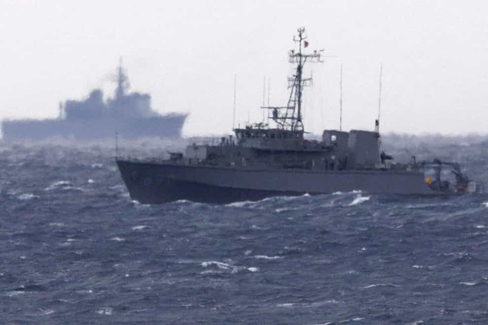 A Japanese ship searches in the waters where a military Osprey aircraft crashed (Kyodo News/AP)
