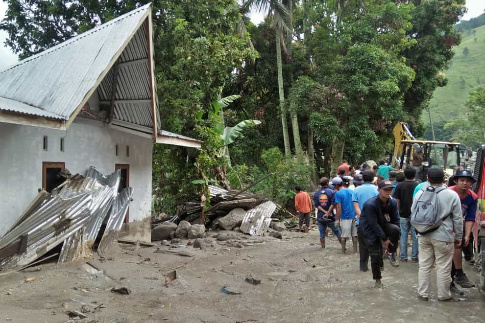 Torrential rain triggered flash floods and a landslide on Indonesia’s Sumatra island, leaving one man dead and 11 other people missing, officials said (Hermanto Tobing/AP)