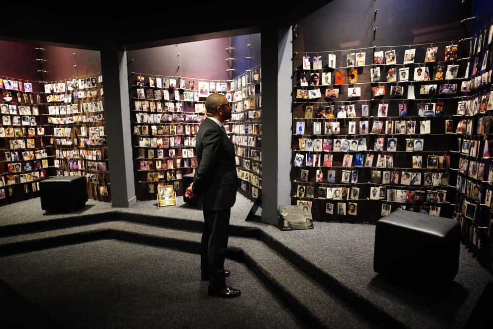 Home Secretary James Cleverly views photographs of victims of the genocide at the Kigali Genocide Memorial (Ben Birchall/PA)