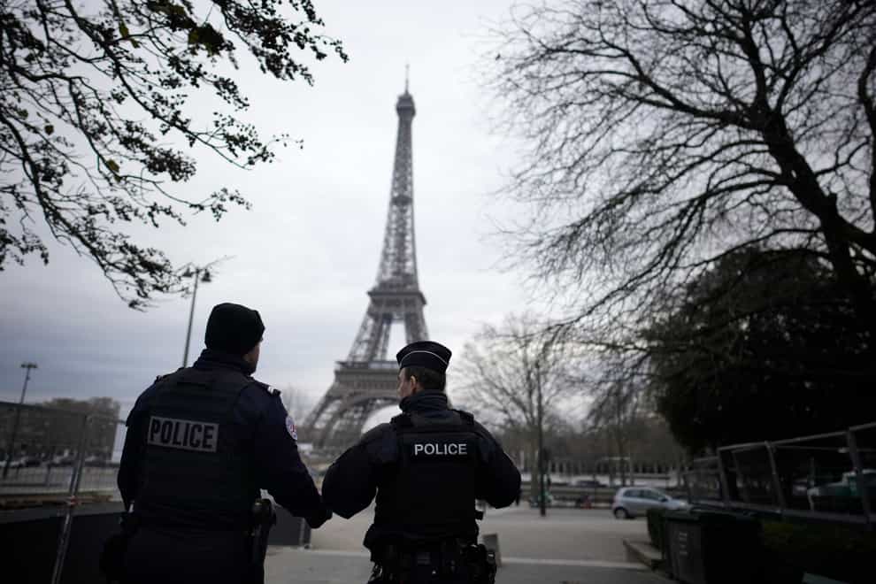 French policemen patrol near the Eiffel Tower after the attack (Christophe Ena/AP)