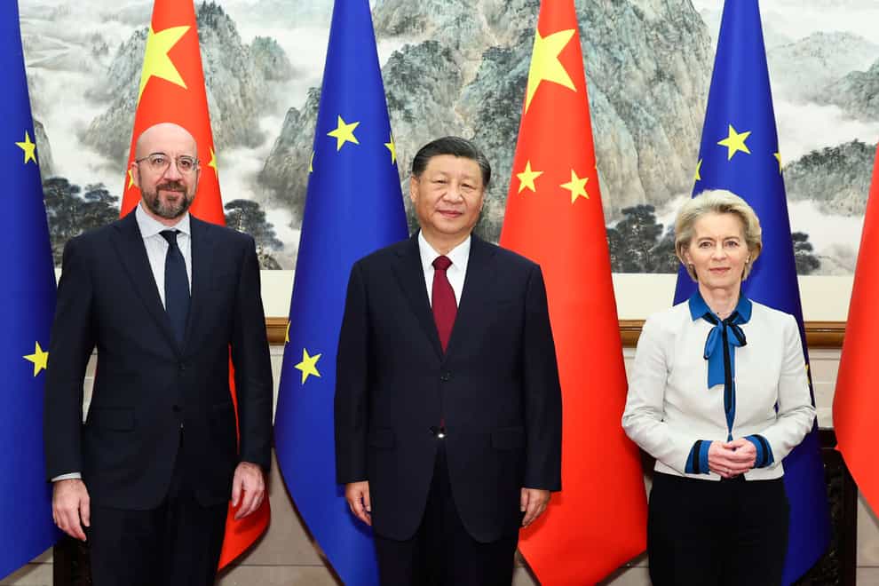 Chinese President Xi Jinping, centre, stands for a group photograph with European Commission president Ursula von der Leyen, right, and European Council president Charles Michel prior to their meeting at the Diaoyutai State Guesthouse in Beijing (Huang Jingwen/Xinhua via AP)