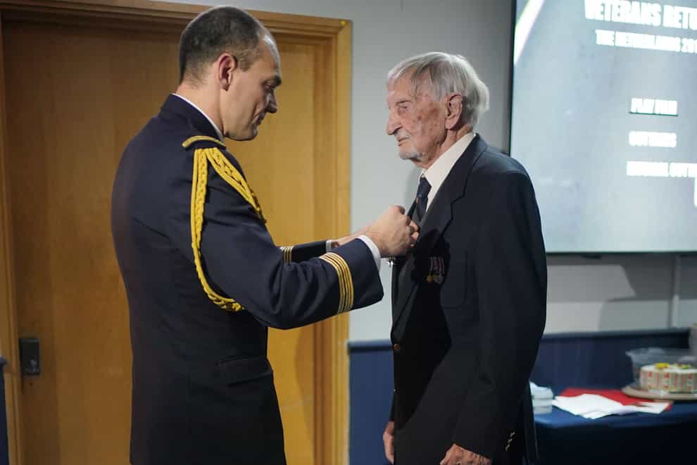 French Colonel Xavier Ravel (left) surprises 100-year-old veteran David Morgan with the Legion of Honour (Yui Mok/PA)