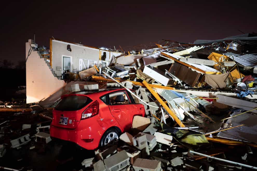 A car is buried under rubble on Main Street after a tornado hit Hendersonville, Tennessee (Andrew Nelles/The Tennessean/AP)