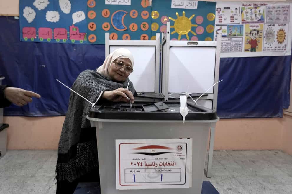 A woman casts her vote in the presidential elections at a polling station in Cairo (Amr Nabil/AP)