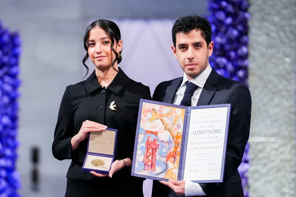 Kiana and Ali Rahmani receive the Nobel Peace Prize on behalf of their mother, imprisoned Iranian activist Narges Mohammadi, in Oslo City Hall (Javad Parsa/NTB via AP)
