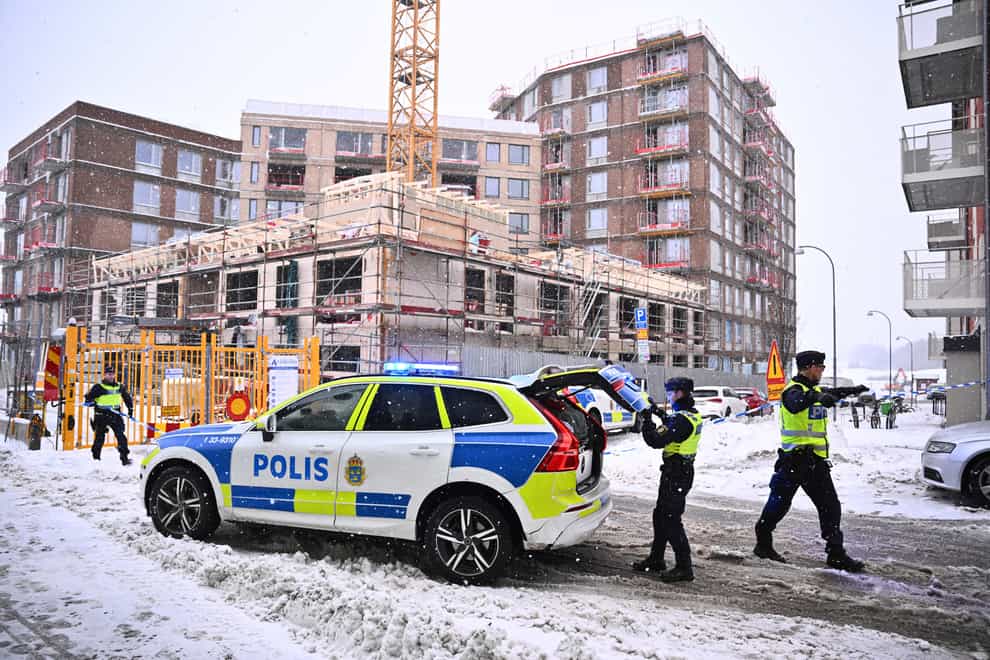 Police arrive at the site where a construction lift crashed to the ground on a building site in Sundbyberg, near Stockholm (Claudio Bresciani/TT News Agency via AP)